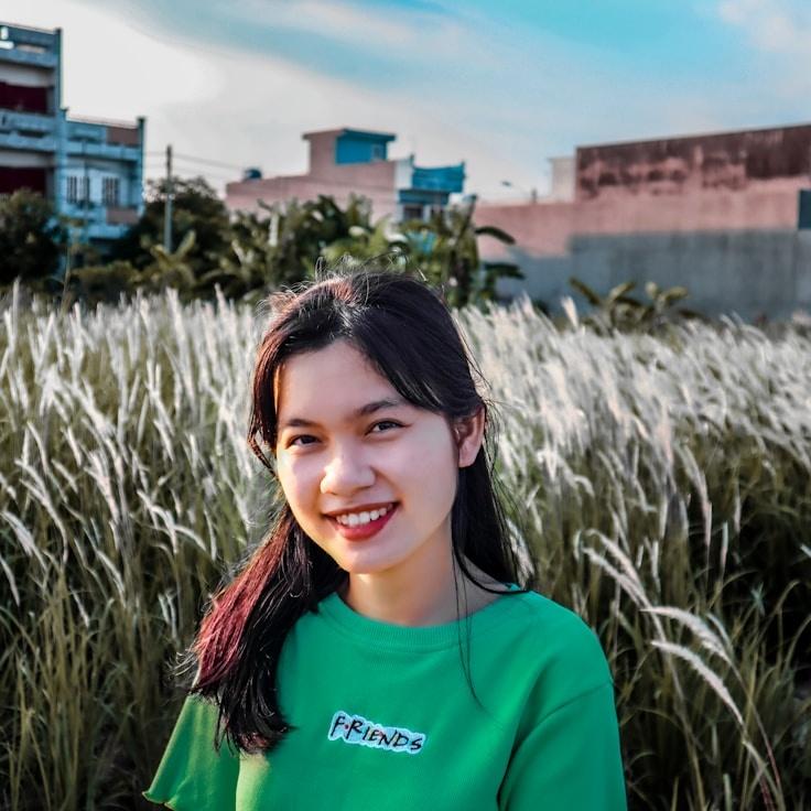 Avery Kim, Lead Design Curator at OakRunFit, reviewing corporate floral arrangements